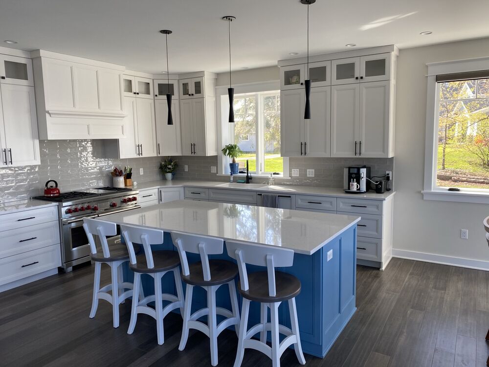 Custom kitchen with a blue island and white cabinetry